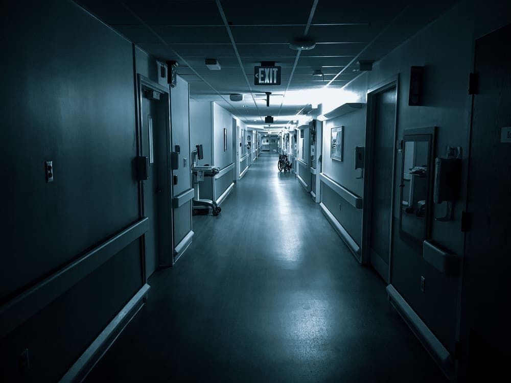 A long, dimly lit hospital corridor