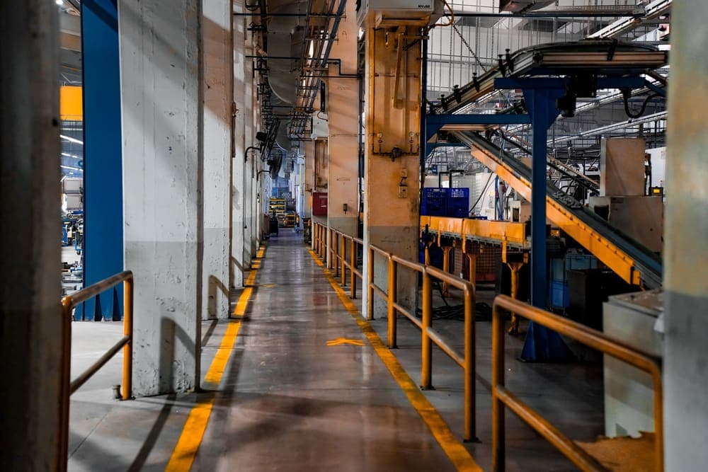 Walkway beside a conveyor line on a factory floor